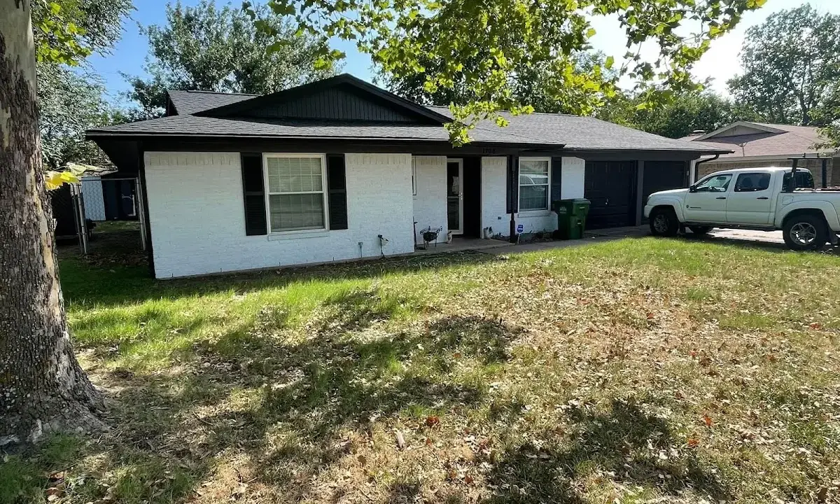 Professional roofing crew working on a residential roof in Highland